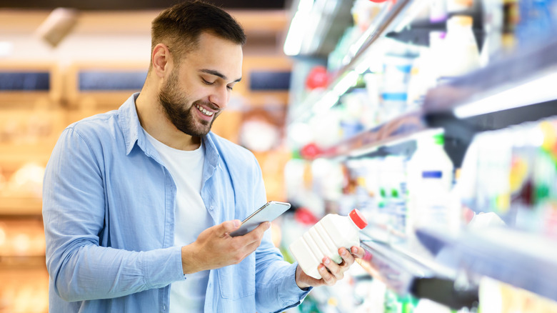Man in grocery dairy aisle