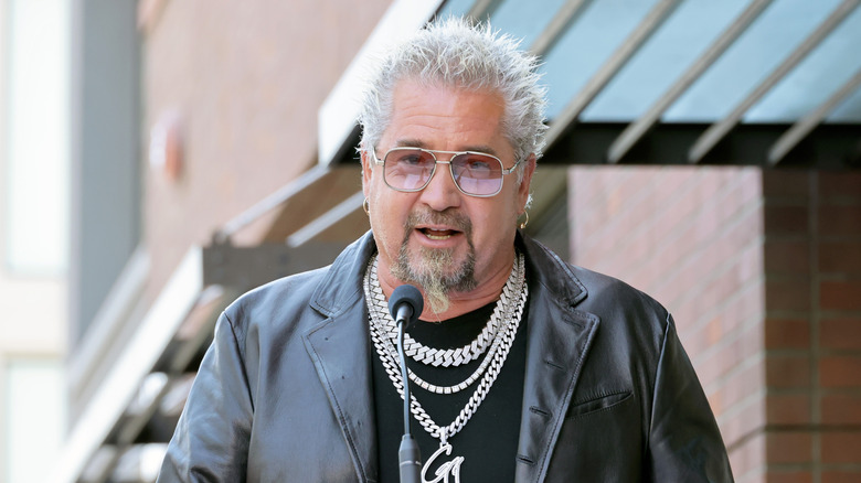 Guy Fieri in front of a mircophone