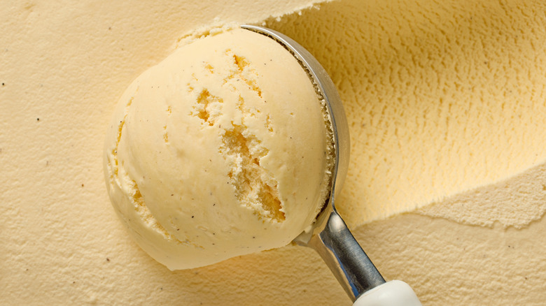 Close up on a scoop scooping vanilla ice cream