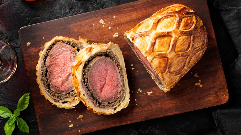 Beef Wellington sliced on board