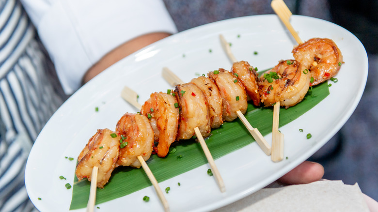 plate of shrimp on skewers