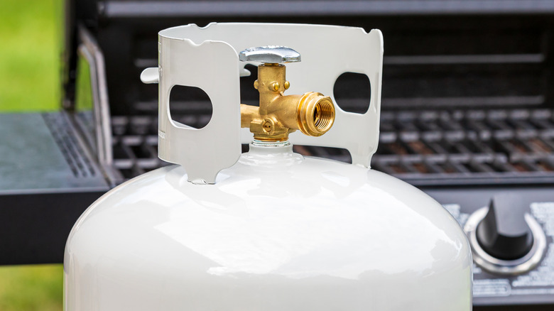 propane tank in front of grill