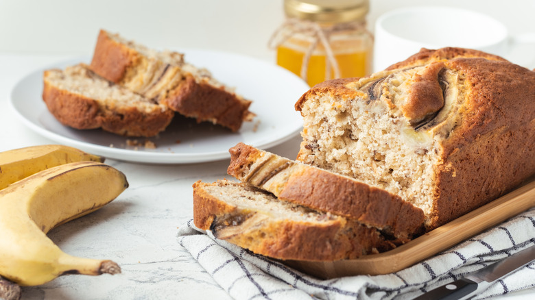 Sliced banana bread loaf with bananas