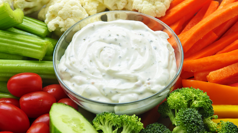 Ranch dip surrounded by raw vegetables