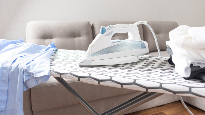 Iron and clothing on an ironing board