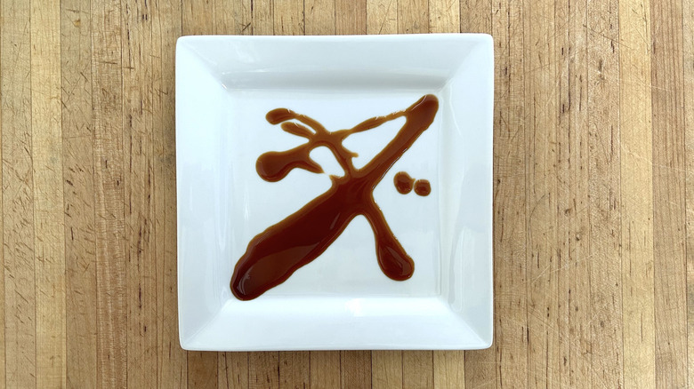 Wooden cutting board with chicken slices marinaded in Mr. Yoshida's Original Japanese Barbecue Gourmet Sweet Teriyaki Marinade & Cooking Sauce