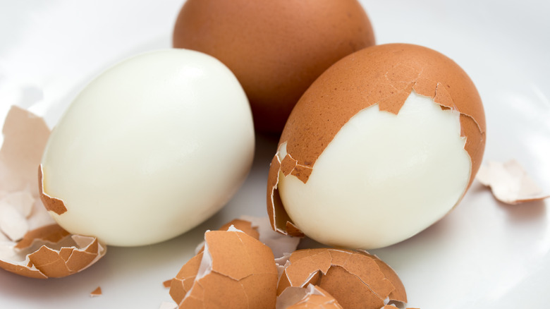 Partially peeled hardboiled eggs