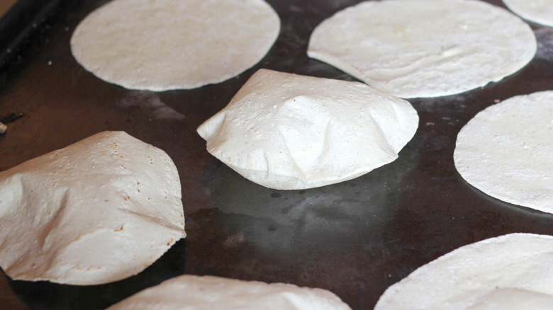 Puffy corn tortillas cooking
