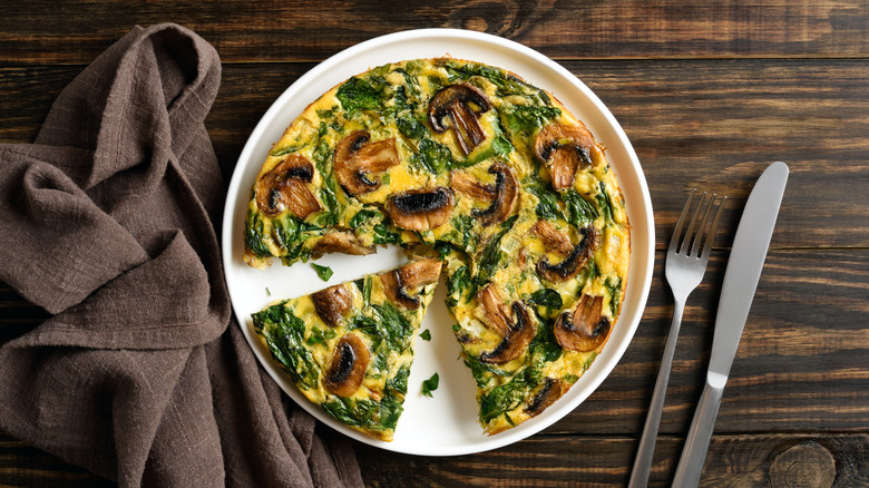 Frittata on a plate on a wooden table