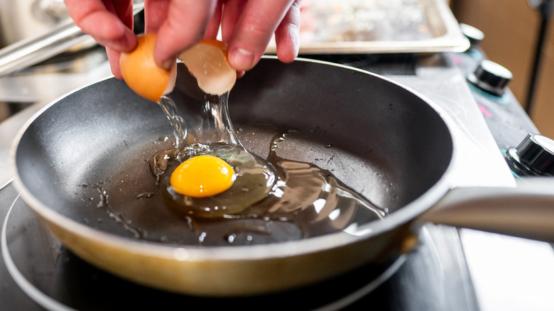 Cracking an egg over a non-stick pan