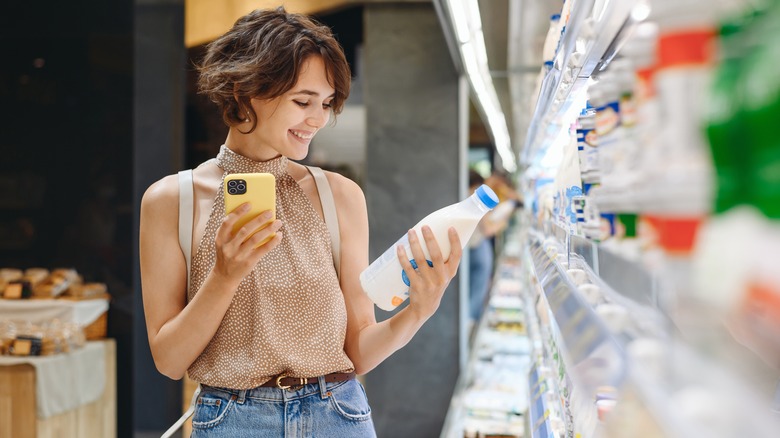woman shopping for dairy products in store