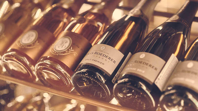 Bottles of Champagne on a rack in a restaurant