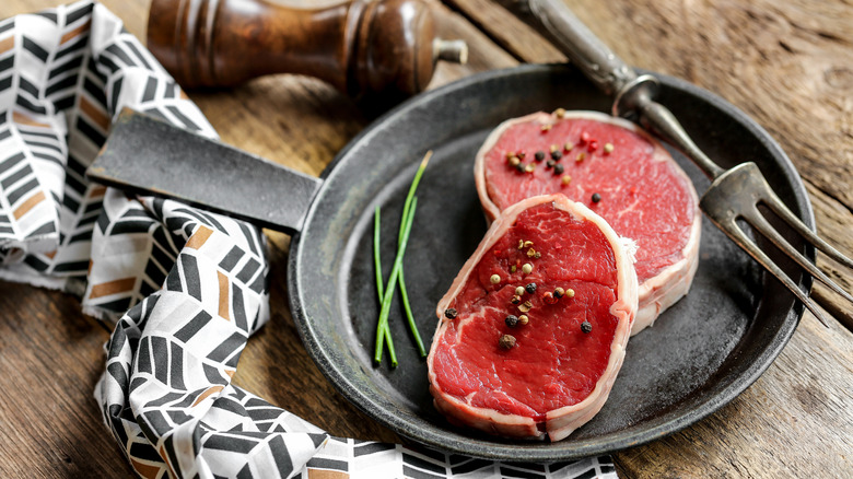 Barded steak in iron skillet