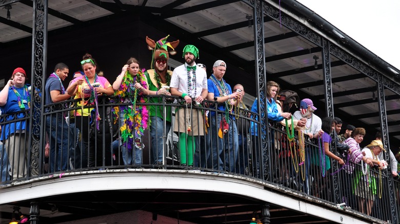 People with beads on balcony