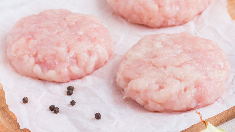 raw ground chicken formed into patties