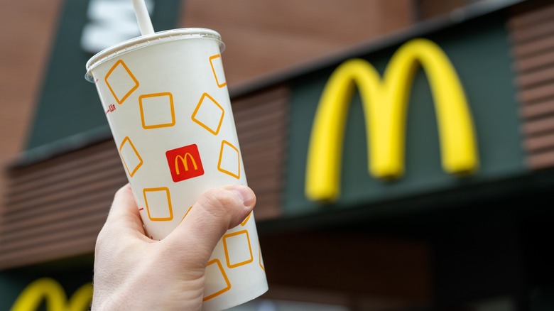 person holding mcdonald's drink
