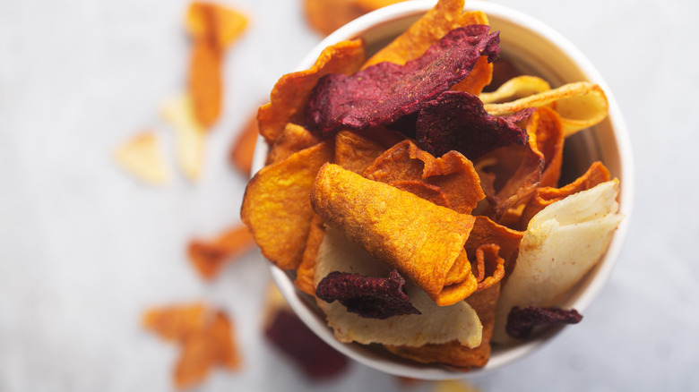 Variety of veggie chips in a white bowl