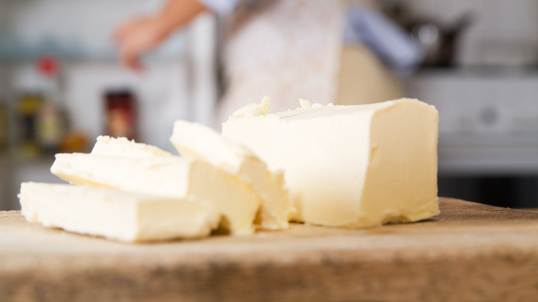 sliced block of butter on a chopping board