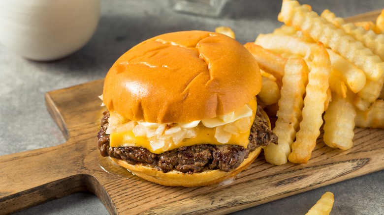 Burger with fries on board