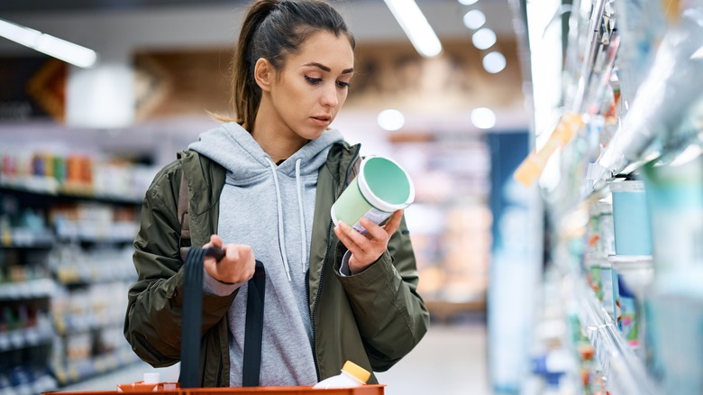woman reading nutrition label
