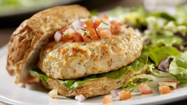 two turkey burgers on white plate 