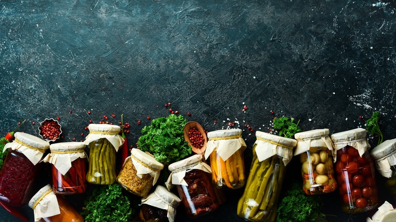 Jarred vegetables on a dark background