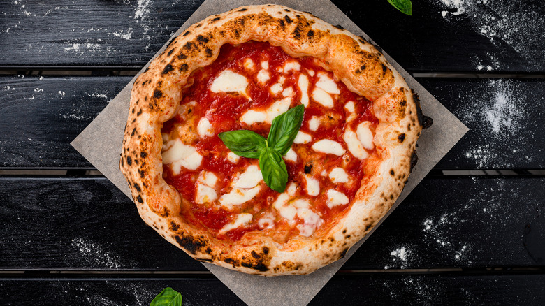 Margherita pizza with fresh basil leaves 
