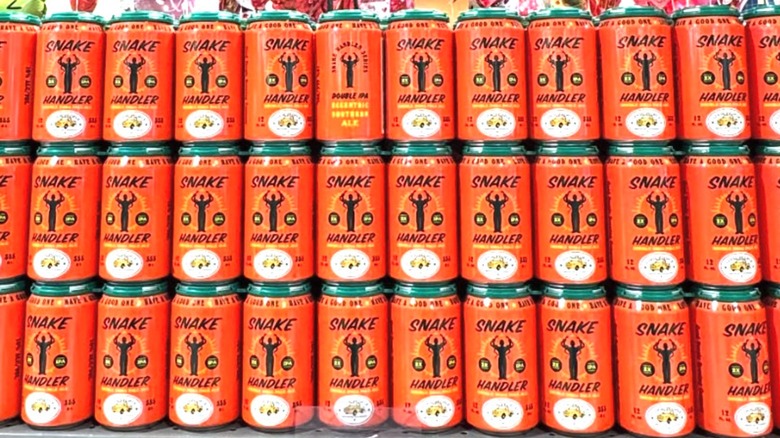 cans of snake handler beer stacked on store shelf