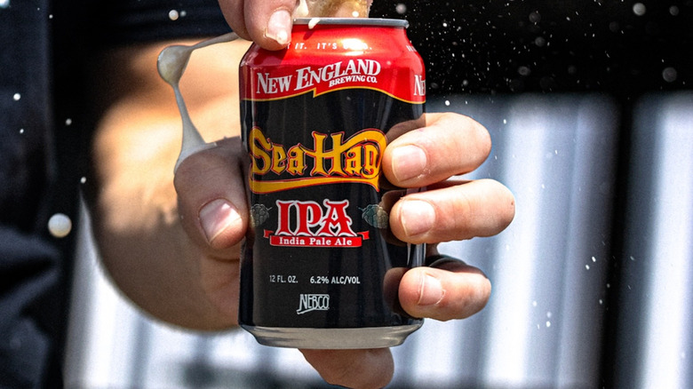 hand opening a can of sea hag ipa beer
