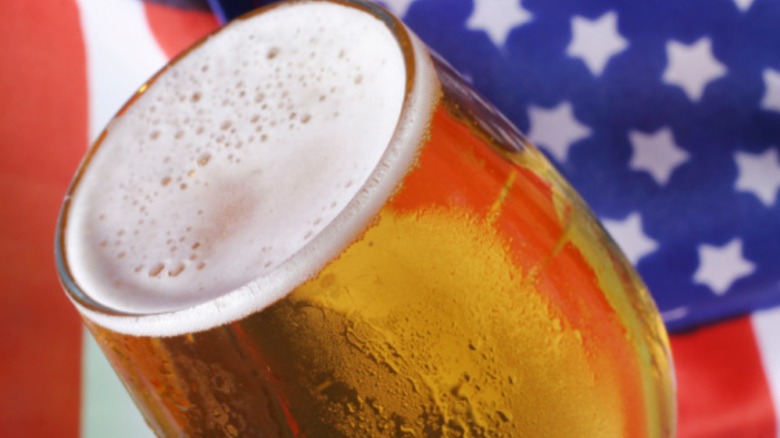 close up of beer in glass with american flag background