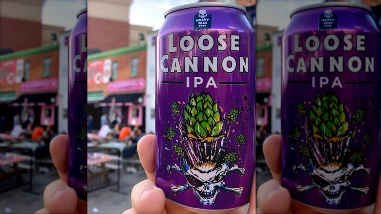 hand holding can of loose cannon ipa outside