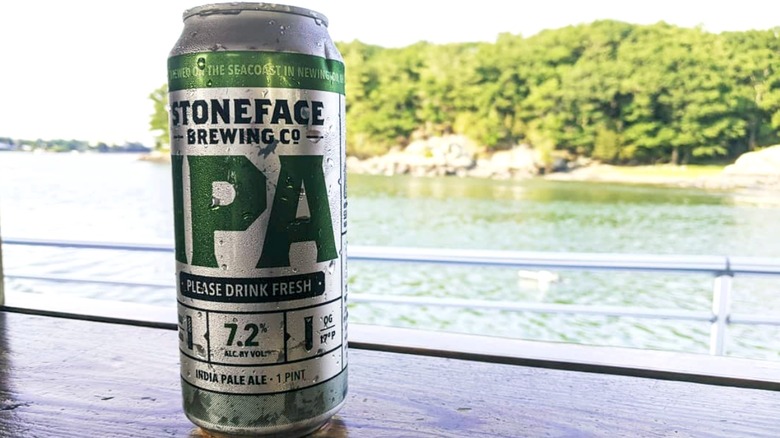 can of stoneface ipa on table overlooking water