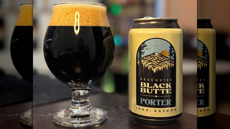 glass and can of black butte dark beer on table
