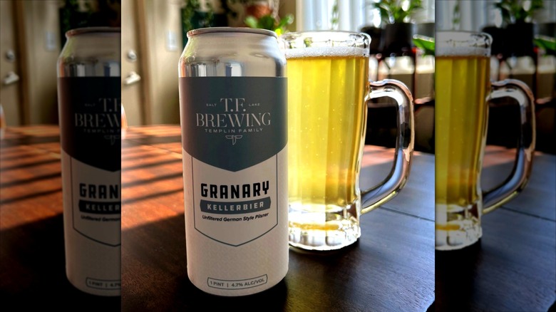 glass and can of beer on sunlit table