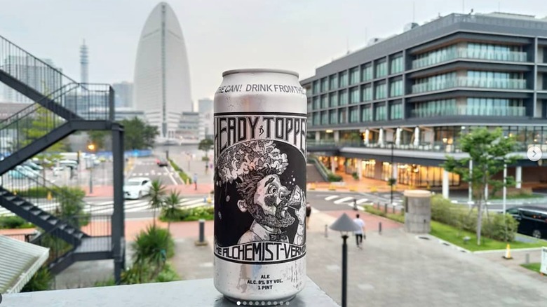 can of heady topper beer on outside railing overlooking city