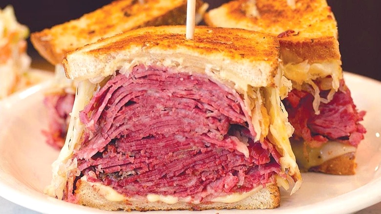 Pastrami on rye on white plate