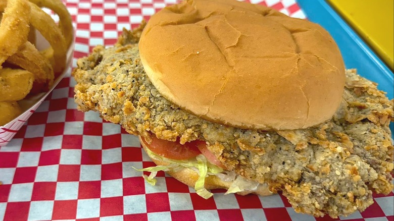 Chicken-fried steak sandwich with onion rings