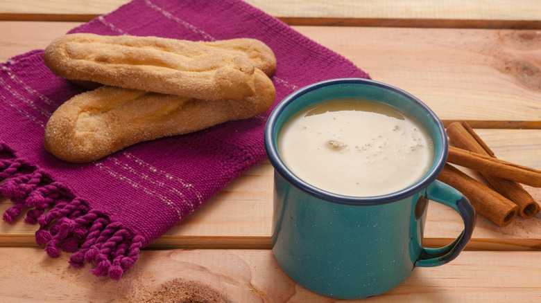 Atole in a mug with bread