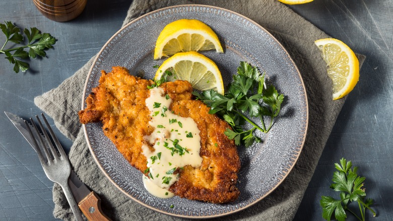 fried chicken schnitzel with gravy on plate