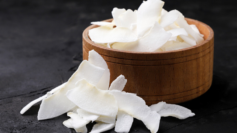 coconut flakes in wooden dish