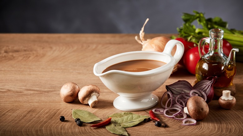 brown gravy ladled into a gravy boat