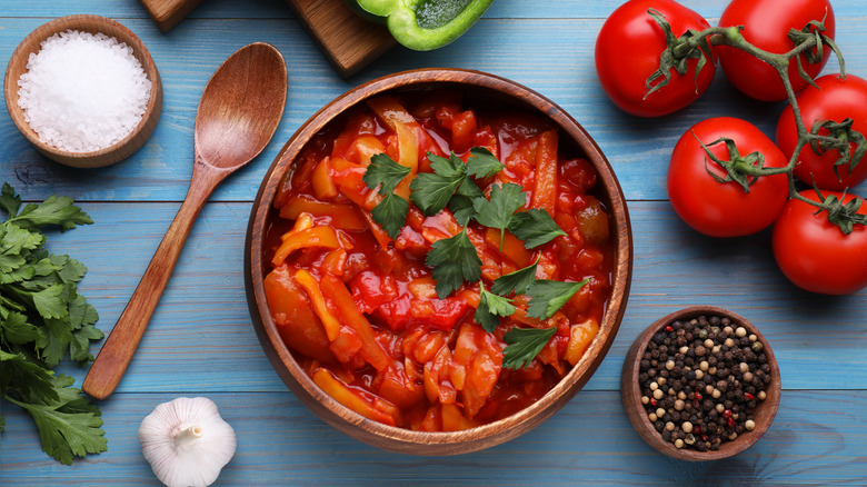 wooden bowl of cooked tomatoes on table