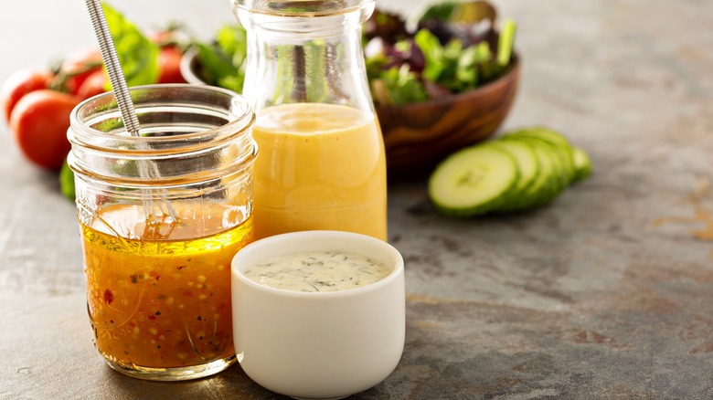 3 jars of dressing on a counter 