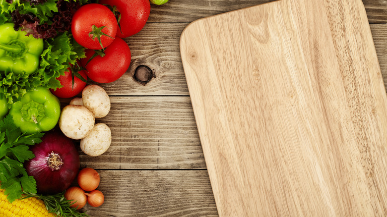 Wooden cutting board with veggies