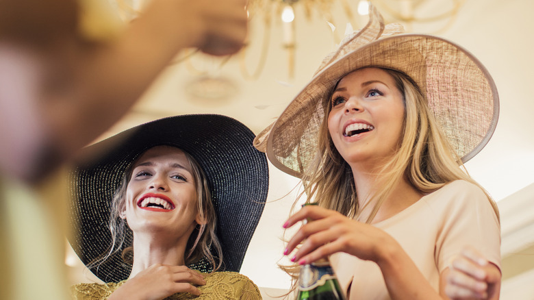 People with big hats at Kentucky Derby party