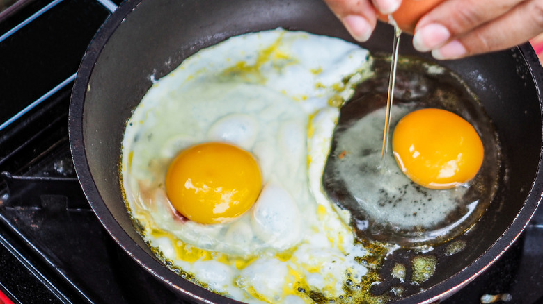 eggs frying in oil in pan