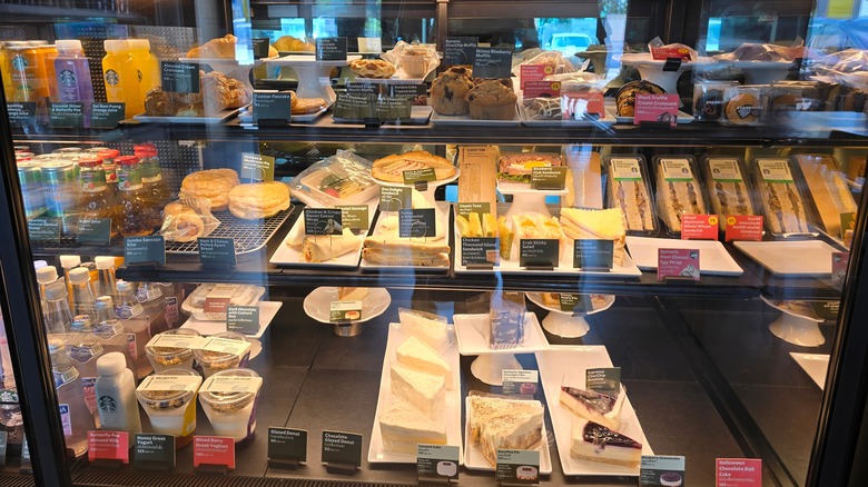 Starbucks display case that includes sandwiches, desserts, and more.