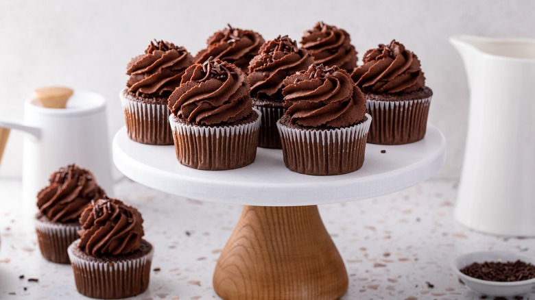 Chocolate buttercream cupcakes on pedestal