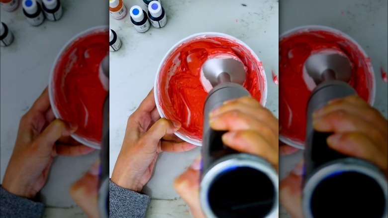 mixing frosting with immersion blender
