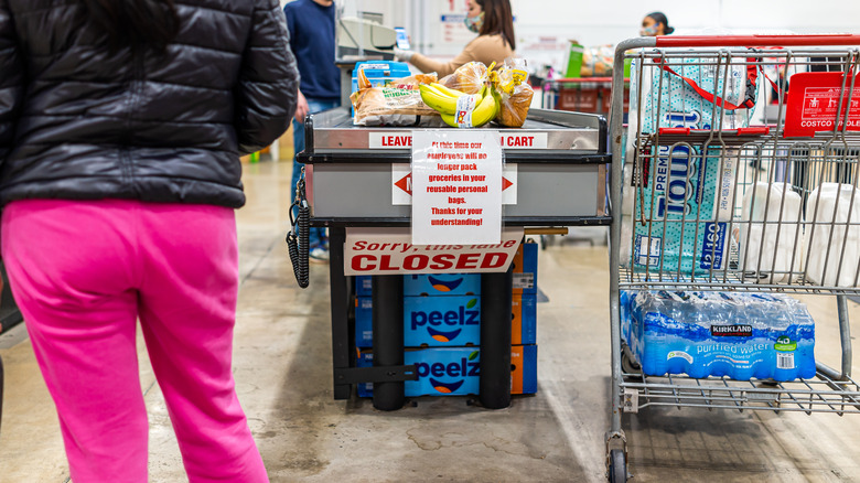 Full shopping cart at checkout register of Costco